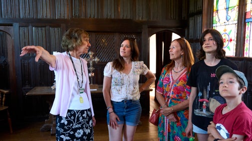 Room guide volunteer talking to family in the New Chapel at Ightham Mote, Kent
